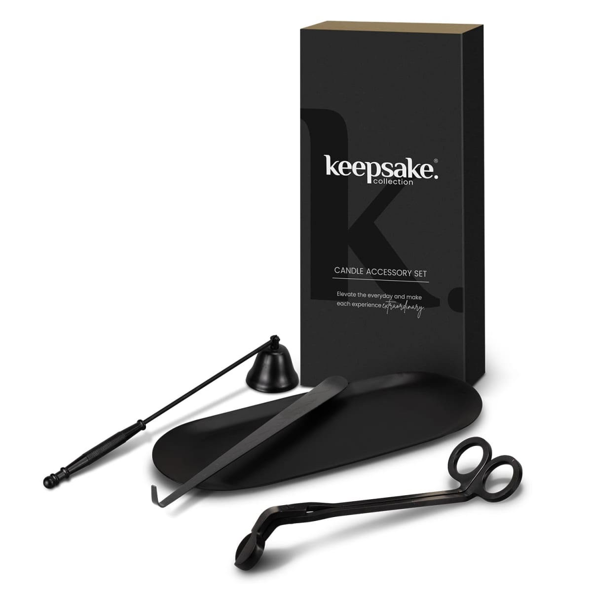 A black candle accessory set featuring a wick trimmer, snuffer, and wick dipper is arranged in front of a sleek, branded black box. The tools have a modern design and are displayed on a matching black tray.