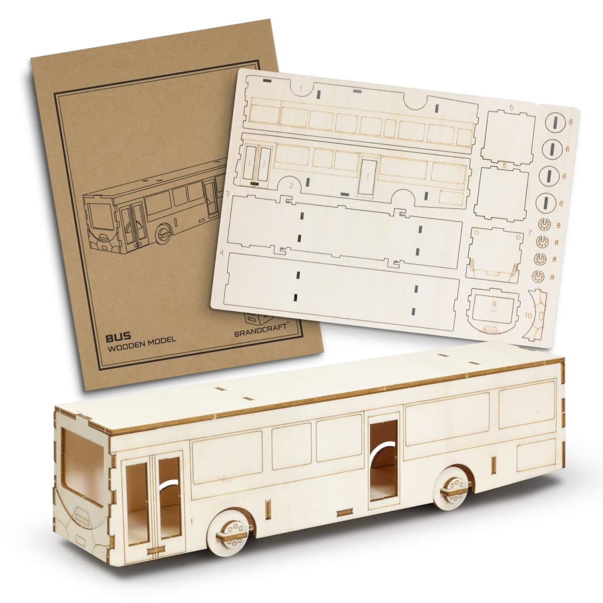 A wooden bus model kit with laser-cut parts for assembly. The image shows a partially assembled bus along with the sheets containing the unassembled pieces and an instruction booklet.