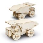 Two wooden model dump trucks are displayed. They are constructed from interlocking wooden pieces, showcasing intricate details like wheels and a tilting cargo bed. The trucks are positioned at different angles for a clear view of their design.