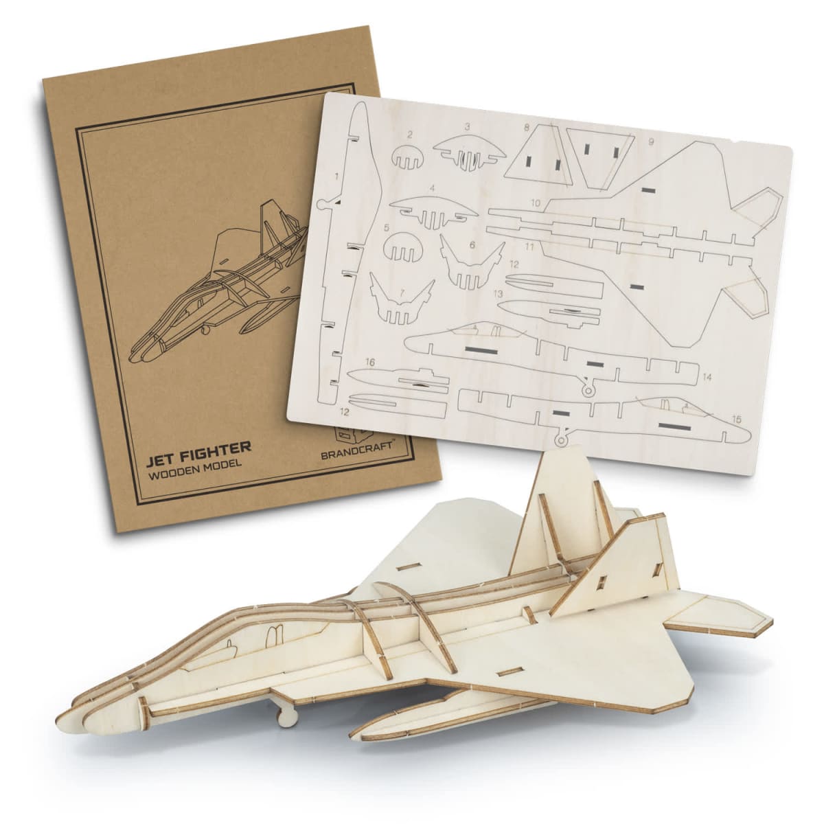 A wooden model jet fighter kit is displayed. The kit includes an instruction booklet and precut wooden pieces arranged on a sheet, alongside a partially assembled jet fighter model.