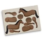 A wooden puzzle featuring a horse, with various detachable pieces such as legs, head, and body parts, arranged around the main horse figure on a light-colored board.