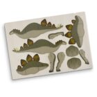Image of a cardboard sheet with die-cut pieces to assemble a 3D model of a Stegosaurus. The parts include a body, plates, and legs, each marked with numbers for easy assembly. The sheet is on a white background.