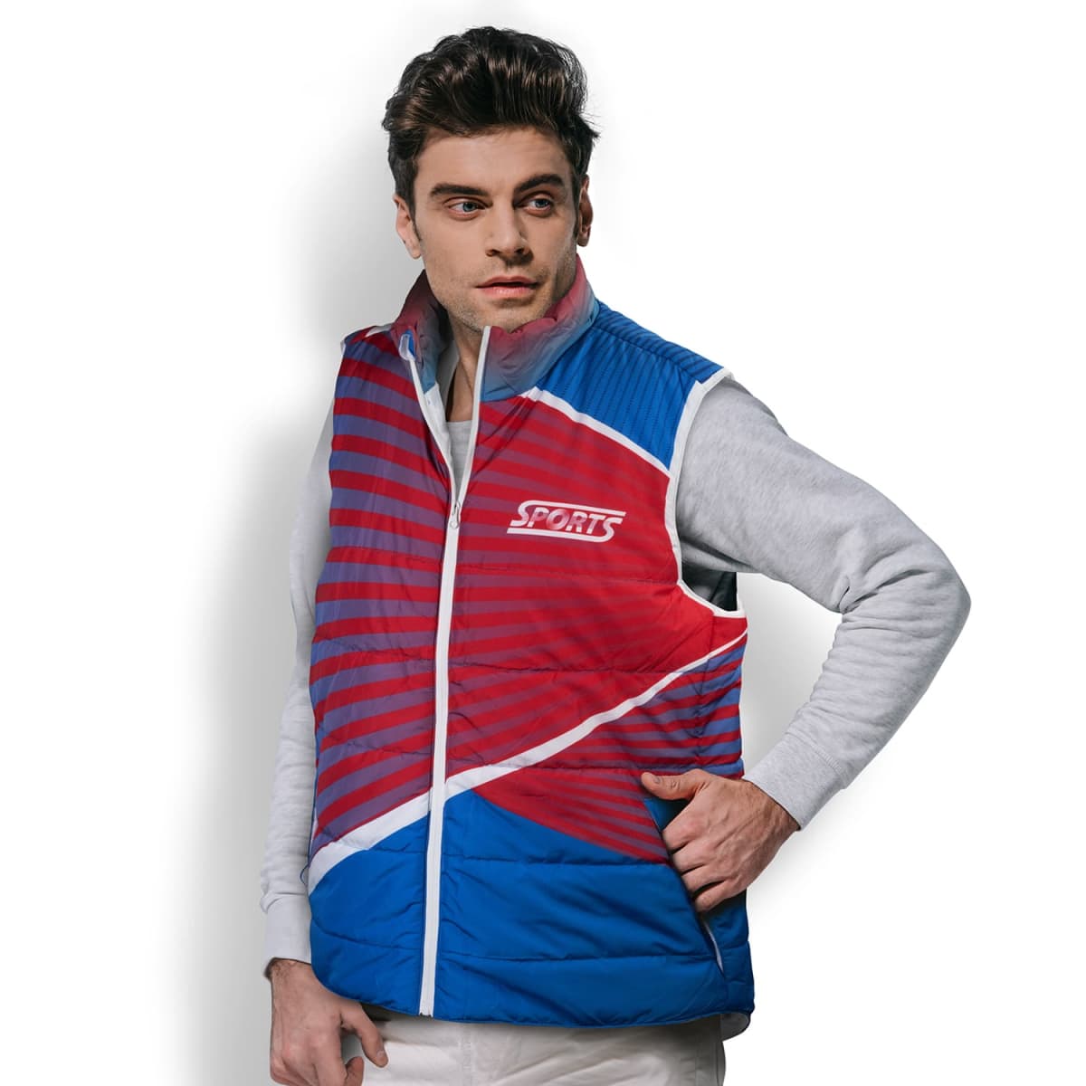 Man wearing a red and blue sports vest with diagonal stripes, over a light gray hoodie. The vest has a SPORTS logo on the chest. He is standing against a plain white background.