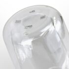 A clear glass container with embossed logos, including a leaf, a dishwasher symbol, and text indicating 320mL capacity. The glass is rounded with a smooth surface, photographed from a side angle.