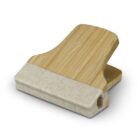 A wooden and white plastic clip with a wide, rectangular shape. The top part is made of textured wood, while the bottom is a smooth plastic grip. The simple design suggests it might be used for sealing bags or holding papers.