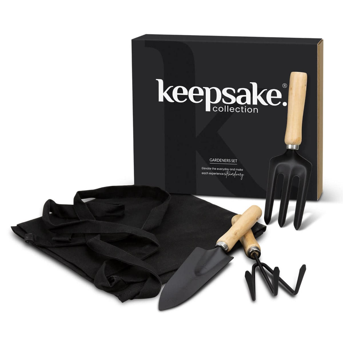 A gardening set from the Keepsake Collection, featuring a black box, a trowel, a fork, a hand rake with wooden handles, and a black apron.