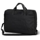 A black fabric briefcase with two short handles and an adjustable shoulder strap. It features a minimalist design with a front pocket and a zipper closure.