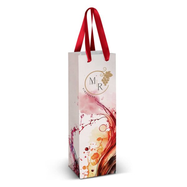 A tall, elegant gift bag designed for wine bottles. It features a blend of vibrant colors with artistic splashes and a logo in gold with the letters MR. The bag has red ribbon handles.