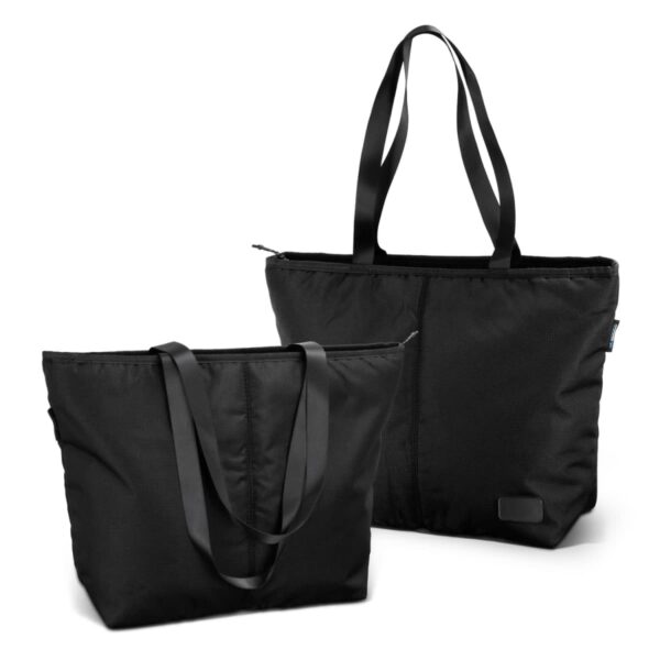 Two black tote bags with long handles are displayed. One bag is zipped and standing upright, while the other is slightly tilted, showing a side view. Both bags have a sleek, modern design.