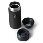 A black insulated travel mug with a silver interior is shown alongside its detachable lid and cup. The components have blue accents and are arranged on a white background.