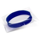 A blue wristband inside a clear plastic wrapper, isolated on a white background.