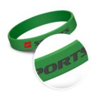 A green silicone wristband with the word SPORTS printed in black. The image includes a close-up circle focusing on the word SPORTS.