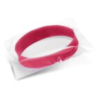 A red silicone wristband sealed in a transparent plastic pouch on a white background.