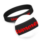 Black silicone wristband with red embossed text love summer. A zoomed-in circular inset highlights the word summer.