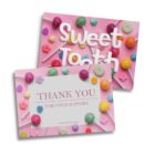 Two colorful postcards with candy designs. One reads Sweet Tooth in white text on a pink background with lollipops. The other has a pink border, reading Thank You For Your Support with the URL sweettooth.com.