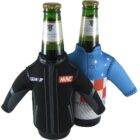 Two green beer bottles wearing small jackets as covers. The left jacket is black with GEAR UP and MAC labels. The right jacket is blue with decorative patterns. Both jackets have long sleeves extending outward.