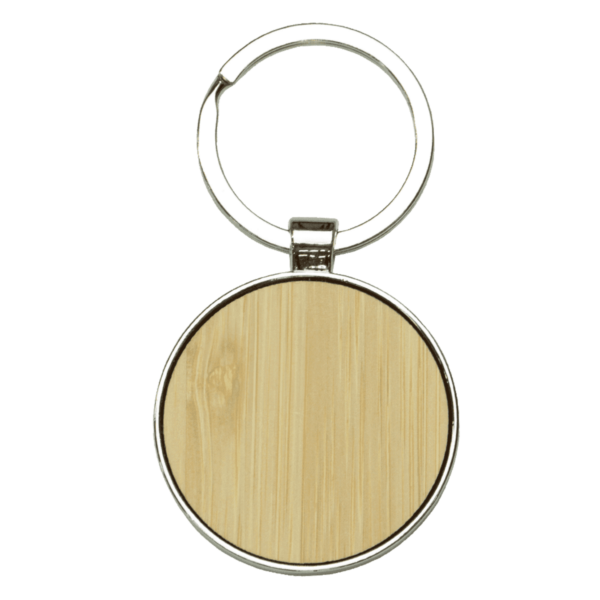 A round wooden keychain with a silver metal ring. The wooden portion is slightly recessed and smooth, framed by the metal edge. The keychain appears simple and elegant, with a natural wood grain visible.