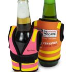 Two beer bottles wearing miniature safety vests. One bottle has a pink and yellow vest, and the other has an orange and yellow vest labeled Certified Locator with a website URL.