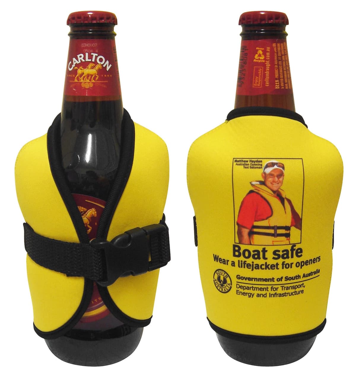 Two beer bottles in yellow lifejacket-shaped coolers. The front of the cooler reads Boat safe: Wear a lifejacket for openers, featuring an image of a person wearing a lifejacket. The coolers are promotional items from South Australia.