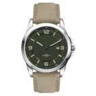 A wristwatch with a green dial featuring white numerals and hands. The date window is at the 3 oclock position. It has a silver bezel and a beige textured strap.