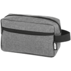 A gray toiletry bag with a black zipper and side handle. The rectangular bag features a front zippered pocket and a small tag with the text R-PET. The fabric appears textured, giving a modern and functional look.