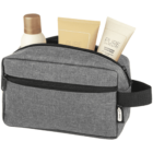 A gray toiletry bag with a front zipper pocket holds three bottles of personal care products, including shampoo and lotion. The bag features a black strap on the side.