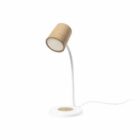 A modern desk lamp with a curved white stand and a cylindrical cork lampshade. It is mounted on a round white base with a power cord extending from the back.