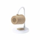 A small, sand-colored speaker with a cylindrical design is mounted on a white stand. The speaker has a simple, minimalist appearance with a wire extending from the top to the base. The base appears sturdy and round.