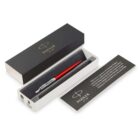 A red Parker pen in a black and white gift box with an informational card beside it.