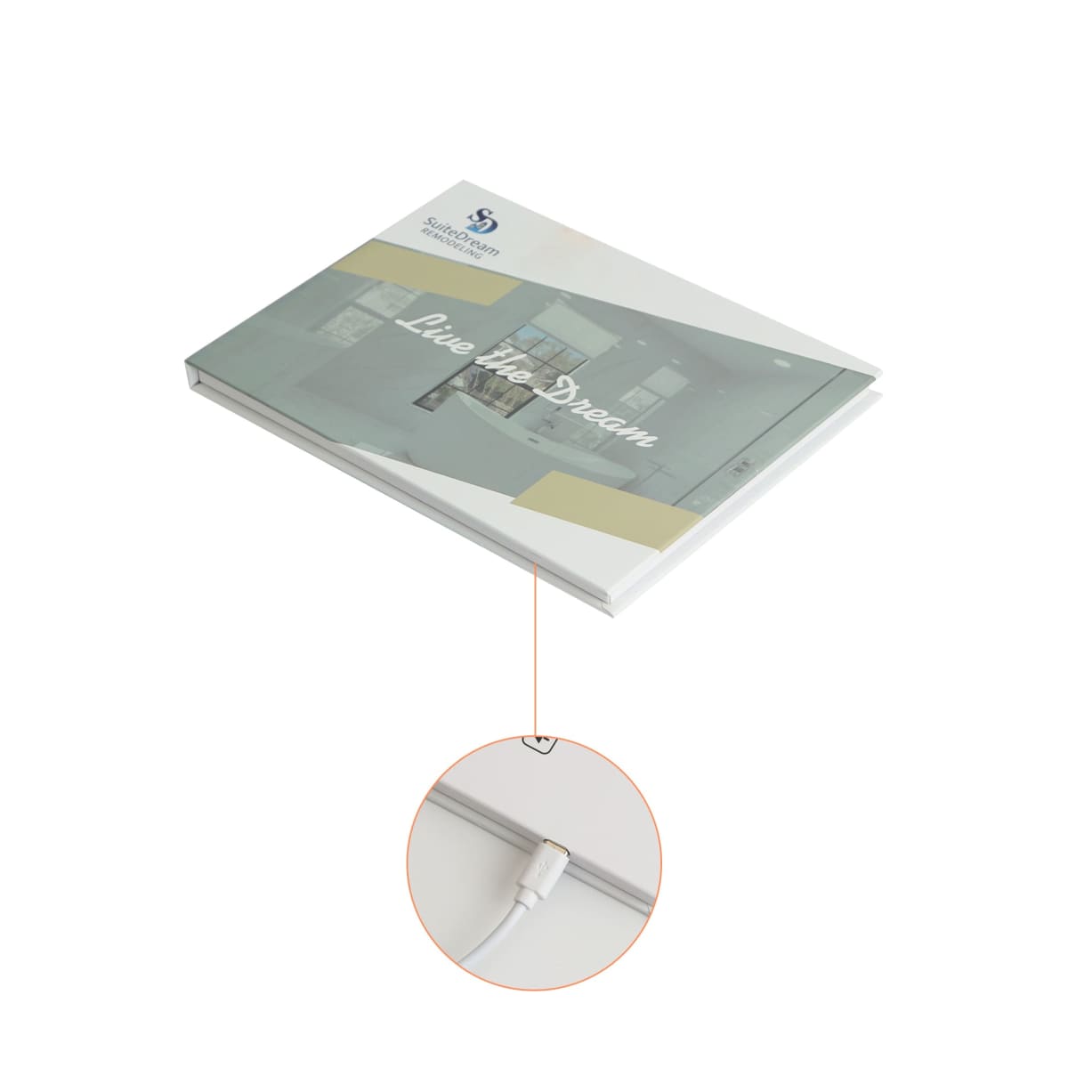 A gray rectangular book with the text Live the Dream on the cover, connected by a wire highlighted in a zoom-in circle. The book is slightly open, revealing some interior content.