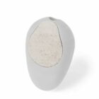 A small, smooth, oval-shaped object with a light gray body and a beige, speckled circular patch on the front. It appears to be made of a soft material, possibly designed for personal or decorative use.