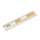 A transparent ruler with pencil slots and a pencil sharpener attached. The ruler displays measurements in both centimeters and inches.