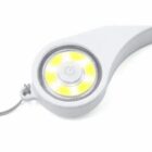 A close-up of a white LED portable light with a circular design. The light is turned on, emitting a bright yellow glow. Theres a power symbol in the center and a lanyard attached to the side.