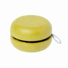 A yellow yo-yo with a speckled texture and a white string.