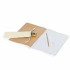 Open notebook with a brown cover and blank white pages. A pencil and eraser rest on one page. A beige cloth pouch holding colored pencils is placed on the other page.