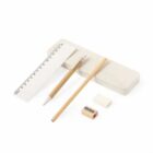 A top-down view of stationery items arranged neatly: a pencil, a wooden ruler, an eraser, a pencil sharpener, and a piece of modeling clay. The background is a clean, white surface.
