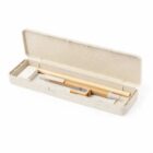 A beige stationery set with a pencil, eraser, and sharpener neatly arranged in an open rectangular case. The set is simple and minimalist in design.
