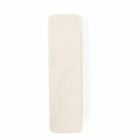 A rectangular, off-white pumice stone with rounded edges and a smooth texture.