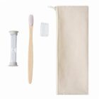 A set of eco-friendly dental care items including a bamboo toothbrush, a compact sand timer, a toothbrush cover, and a beige zippered travel pouch arranged on a white background.