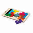A wooden puzzle featuring colorful geometric blocks, including red, green, blue, yellow, white, gray, and brown pieces, neatly arranged within a rectangular frame. A purple piece is placed outside the frame.