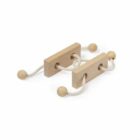 A wooden puzzle consisting of two rectangular blocks connected by a rope threaded through holes, with wooden knobs at each end. The design challenges users to manipulate the parts to solve the puzzle.