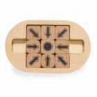 A wooden puzzle with an oval frame contains nine blocks. Eight blocks display black arrows pointing in various directions, surrounding a central block with a black dot. The puzzle has a simple, natural wood finish.