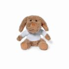 A plush stuffed animal resembling a dog with floppy ears, wearing a white T-shirt. The toy is light brown with darker brown accents on its paws and ears, sitting against a plain white background.