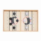 A wooden tabletop game with two sides separated by a barrier. Each side features white and black discs. The board is marked with lines and circular targets, designed for a fast-paced puck-flicking game.