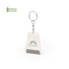 Keychain with a wheat straw tag featuring a sunburst design and the word SUNBURST. The tag is shaped like a wedge and exhibits a grainy texture. The text WHEAT STRAW is displayed in green at the top left corner.