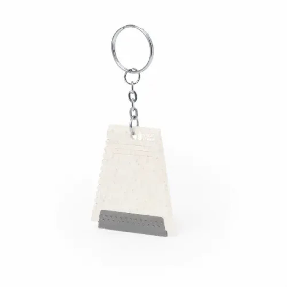 A triangular keychain with a perforated metal piece attached to a metal ring. The keychain is white with small flecks, and the metal piece is rectangular and dark gray, featuring a small perforated section at the bottom.