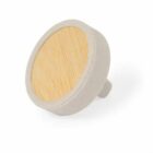 A round beige drawer knob with a wooden center.