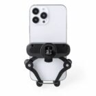 A smartphone with a triple camera setup mounted on a black bike handlebar holder, viewed from the back.