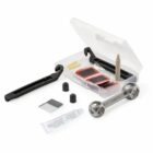 Bicycle repair kit with an open case displaying assorted patches, tire levers, a metal wrench, rubber solution tube, a small file, and valve caps.