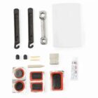 Bicycle repair kit including tire levers, wrench, patches, tube of adhesive, chalk, tire valve caps, sandpaper, and a small white case. Components are neatly arranged on a white background.